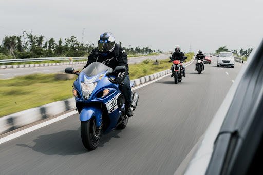 Three motorcycle riders travel down the highway, as seen from another vehicle