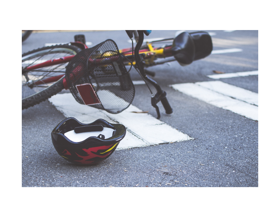 bicycle accident with helmet on ground and bicycle on side