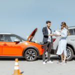 Orange car and white SUV minor fender bender with traffic cones