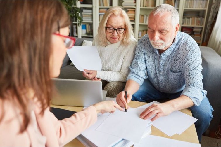 older couple meeting with attorney to sign power of attorney paperwork