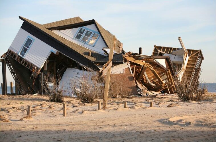 destroyed collapsed home on the beach