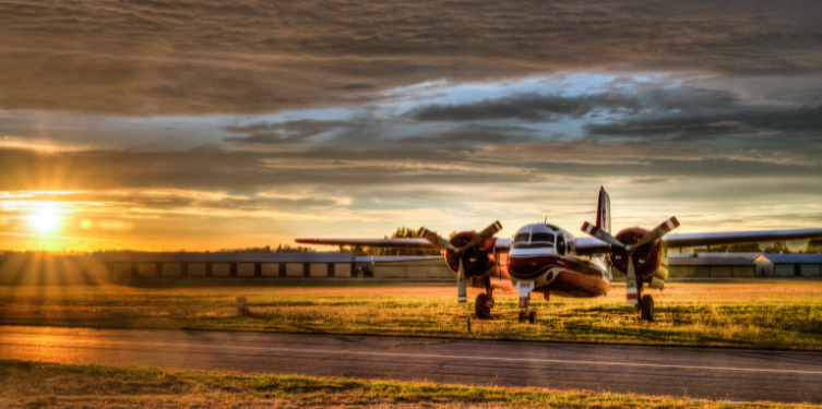 plane cooling down at sunset in barn field