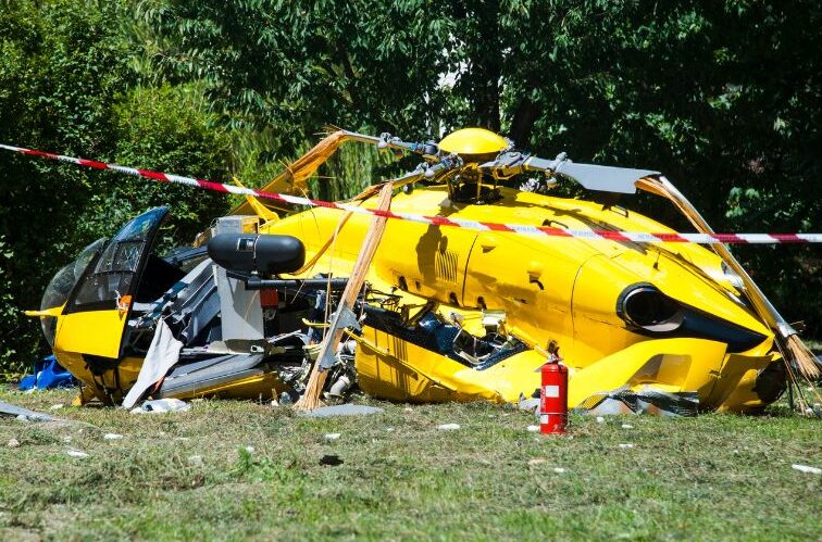 yellow helicopter crash in a field