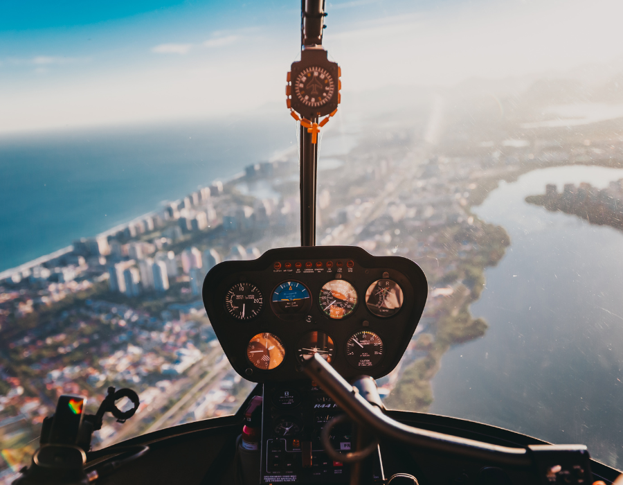 cockpit of helicopter flying over city
