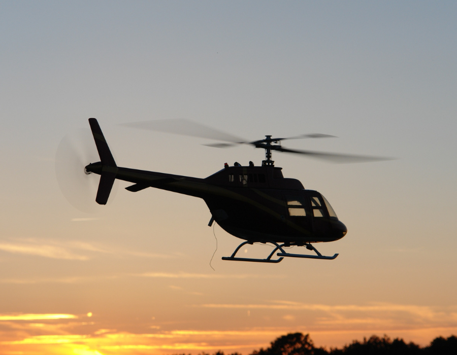 helicopter landing at sunset