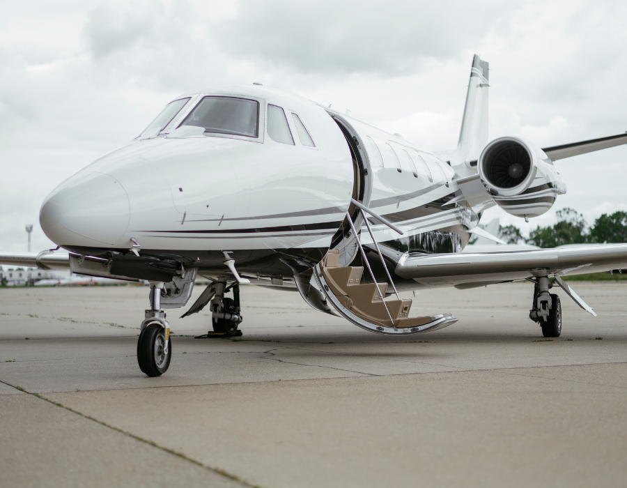 white private jet with stairs down