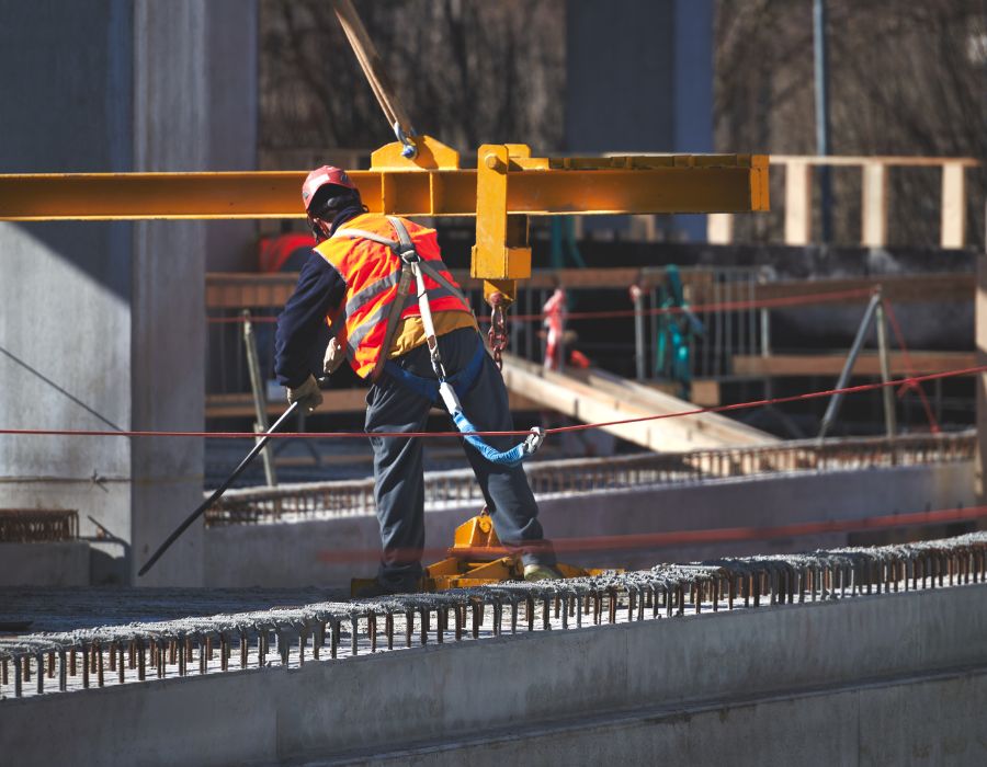 construction worker up high on safety system