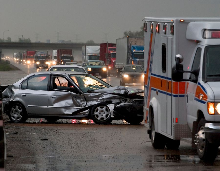 crushed car with ambulance on scene