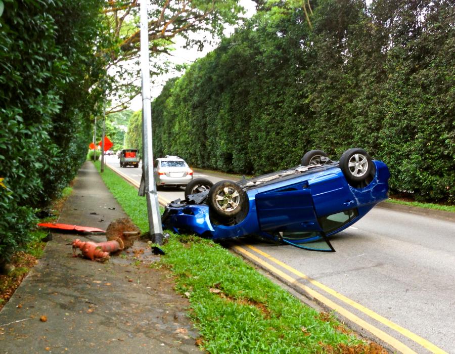 overturned blue car from fatal car crash