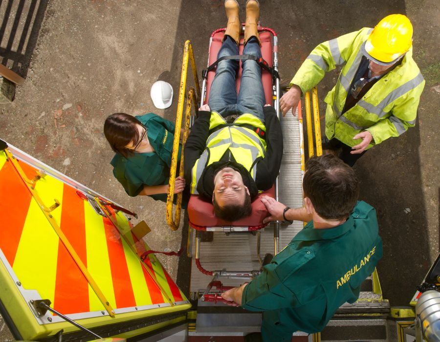 railroad worker being taken away by ambulance