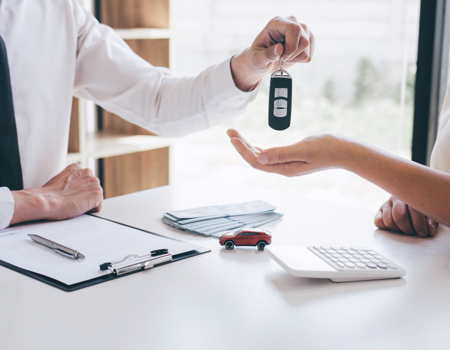 rental agent handing keys over to driver