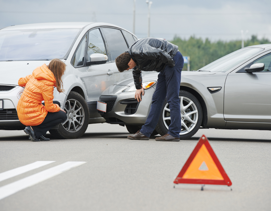 rental car accident scene with woman in an orange jacket and man in a black leather jacket