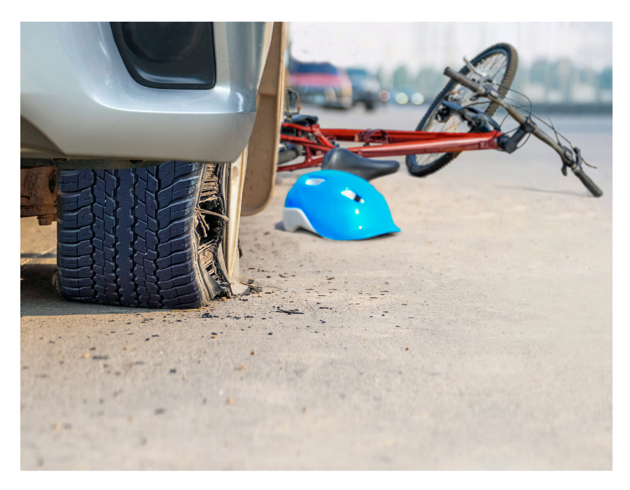 tire blow out accident with crushed bike and helmet on ground