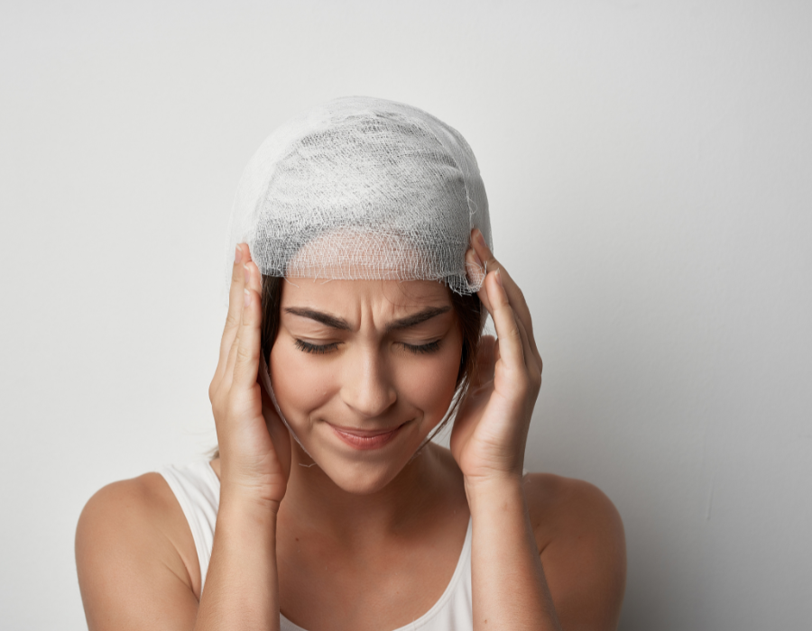 woman with head wrapped after head injury