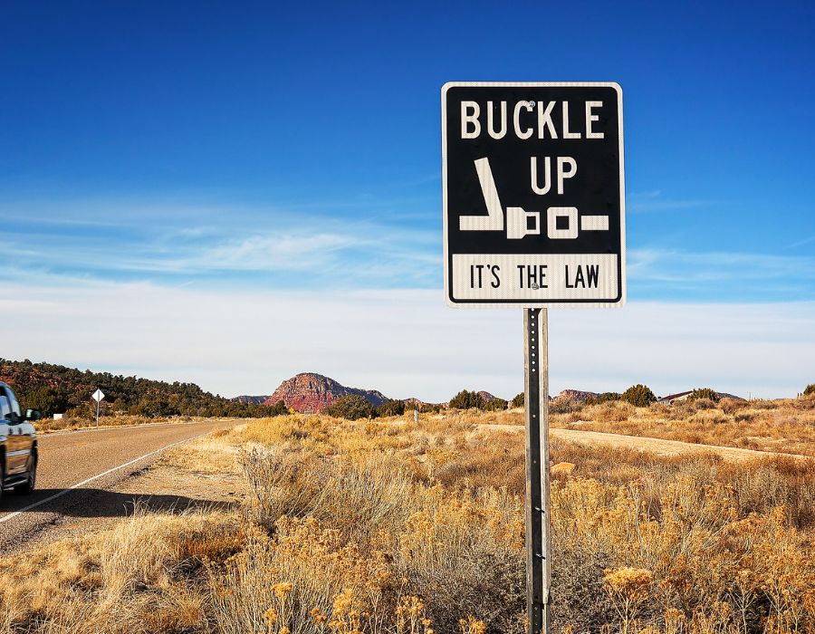 buckle up its the law sign