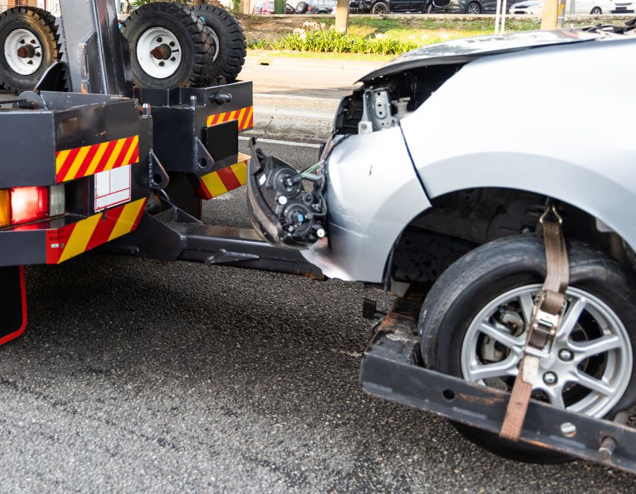 car getting towed after a truck accident