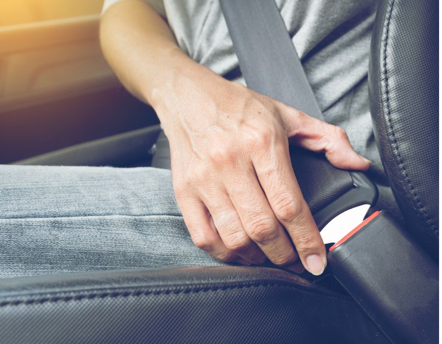 truck passenger putting on seatbelt