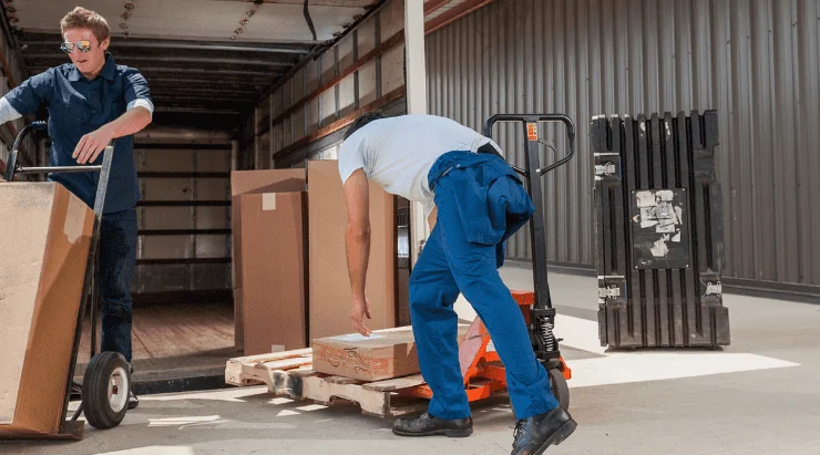 workers unloading boxes off delivery truck