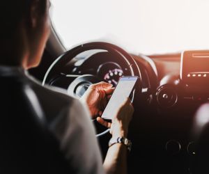 distracted driving - person using cell phone while driving