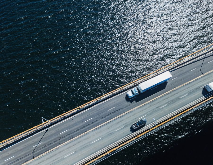 birds eye view of speeding truck on bridge