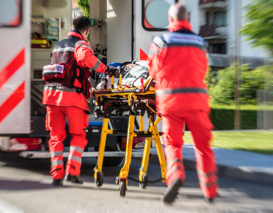 blurred ambulance workers rushing patient to hospital