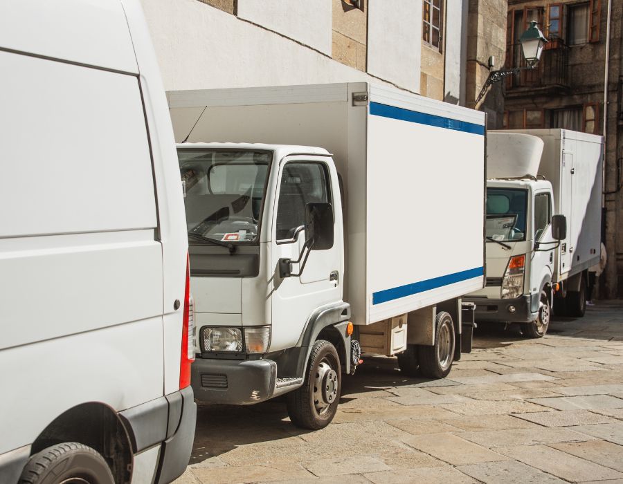 delivery trucks stacked in parking