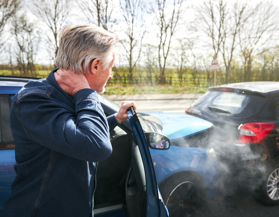 man holding neck after car accident