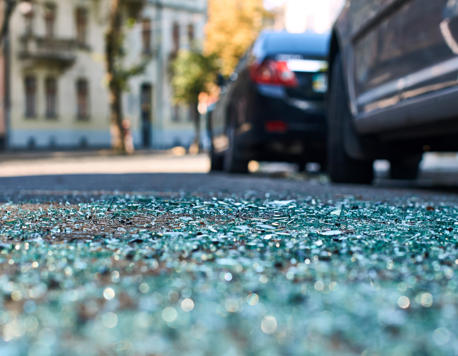 shattered glass on asphalt from wreck