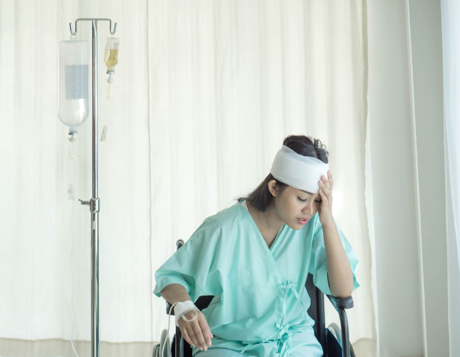 woman patient with head wrapped from brain injury