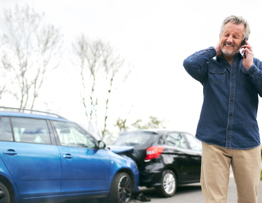 man holding neck after car accident