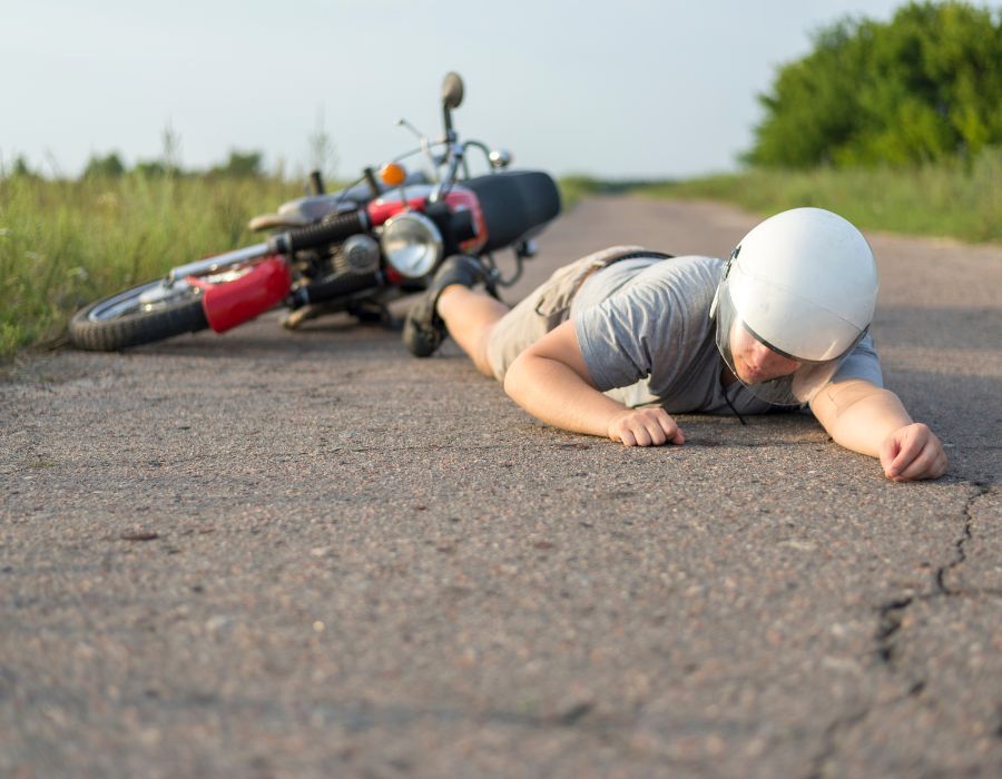 man in road from motorcycle accident