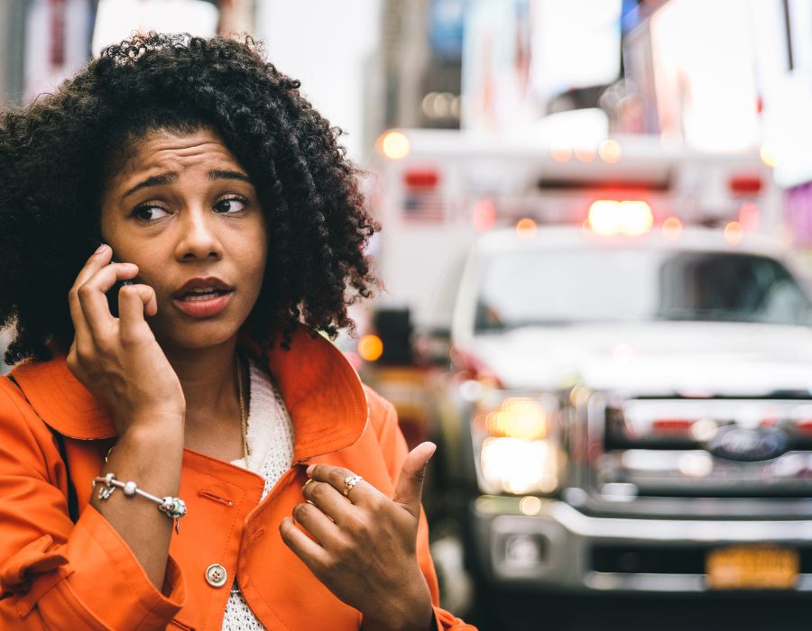 woman on phone at scene of car accident