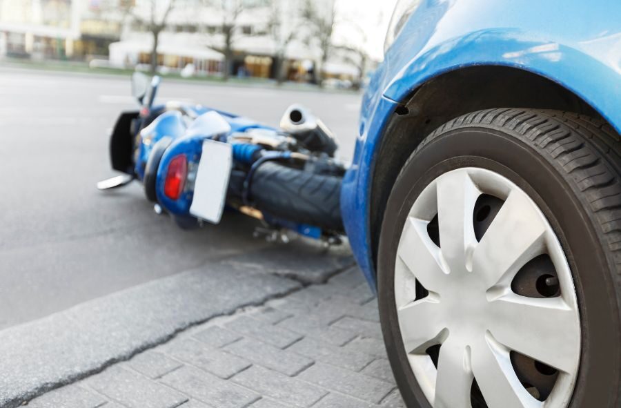 blue car hit blue motorcycle