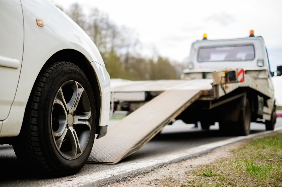 car going on tow truck after truck accident