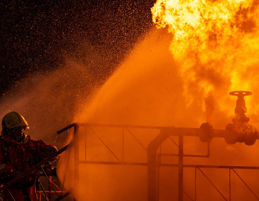 firefighter putting out rig fire