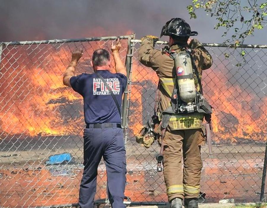 firefighters looking at amazon truck fire