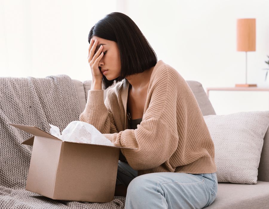 woman in emotional distress over going through loved ones belongings