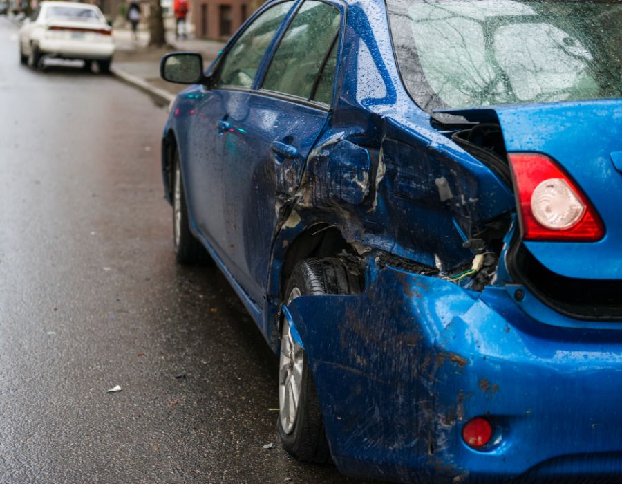 blue car with a crushed left fender