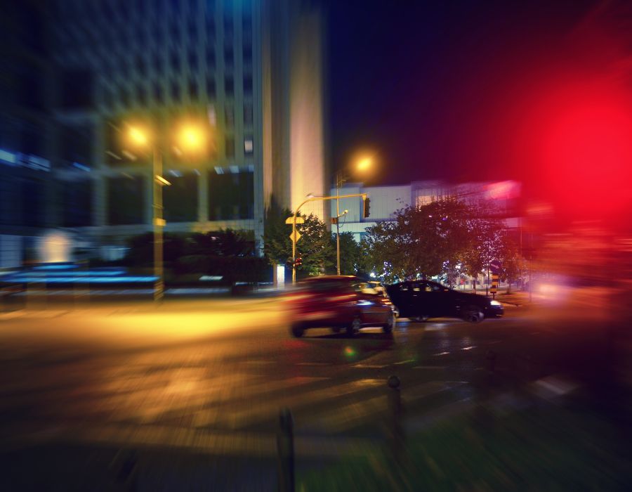 blurred night image with cars getting ready to crash