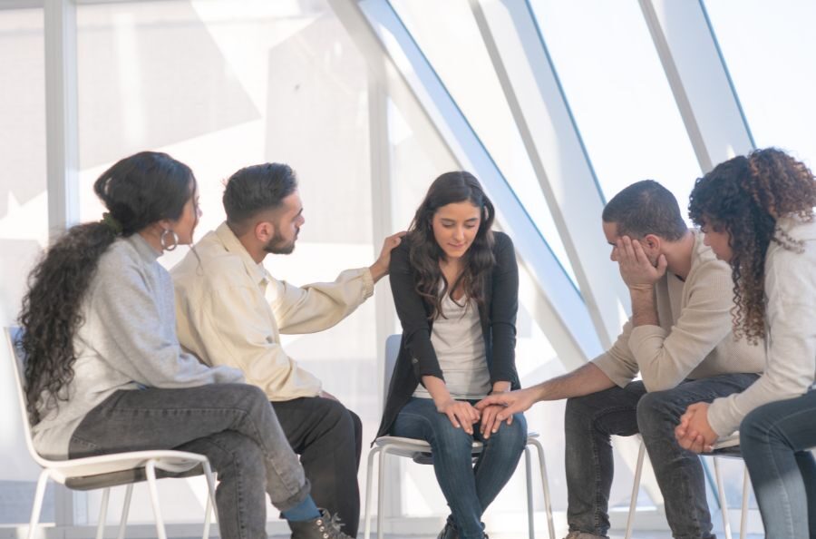 group consoling friend from wrongful death