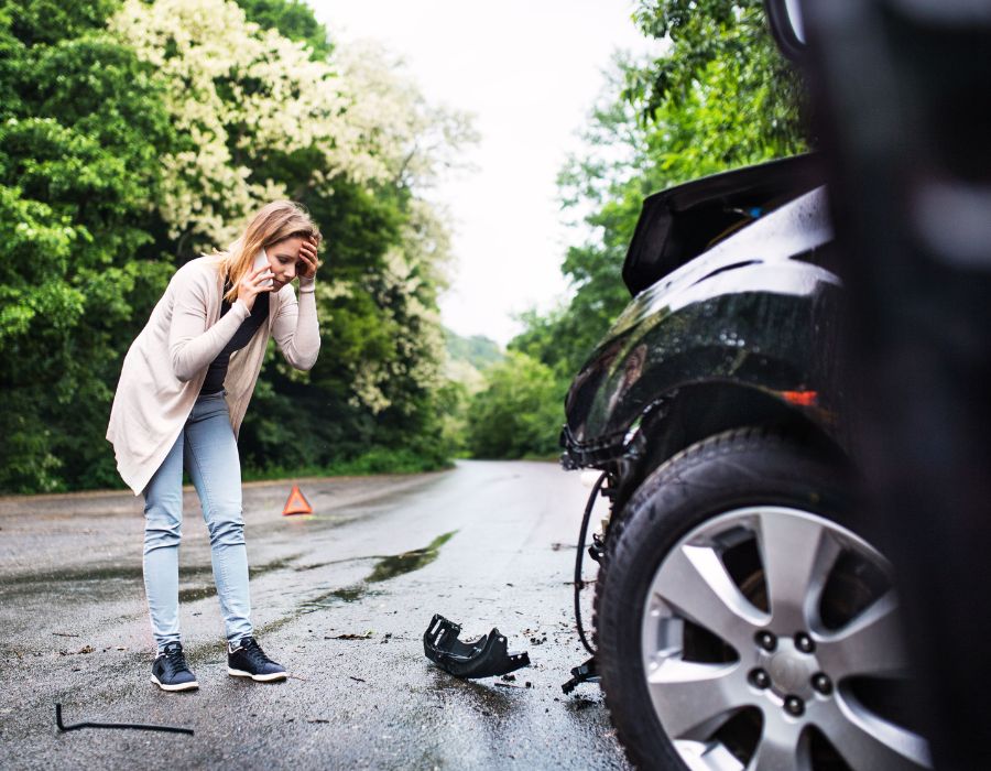 woman checking out her car after a hit and run