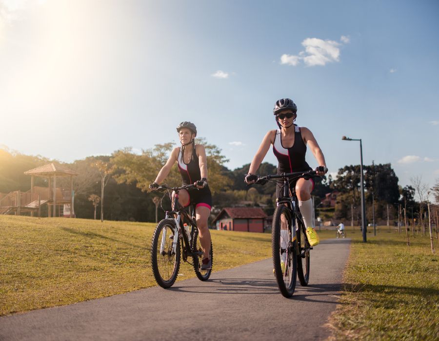 ladies riding bikes through park