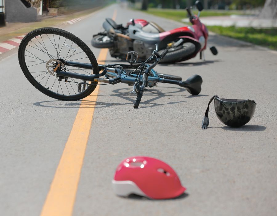 motorcycle and bike on road knocked over