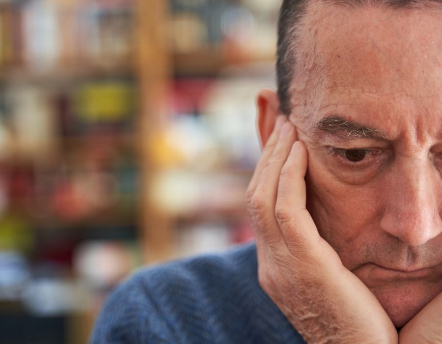 older man holding temples