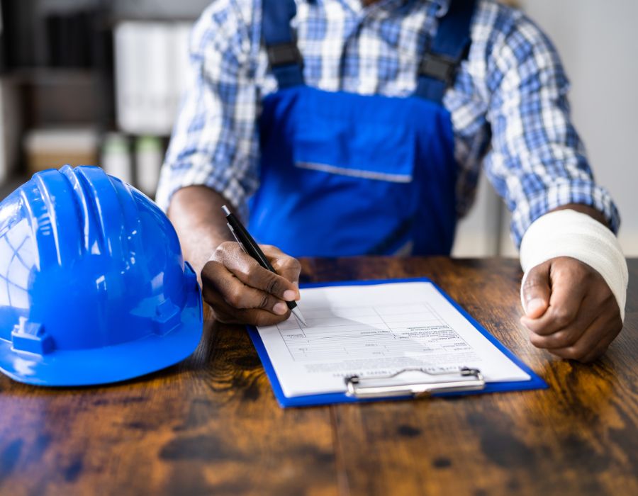 injured construction worker signing legal documents