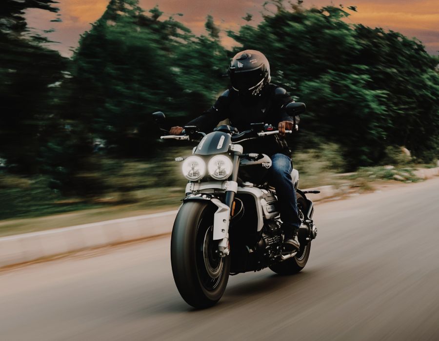 Man riding a motorcycle in the evening