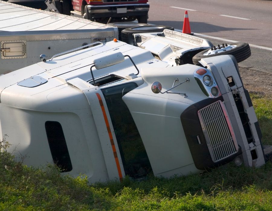rolled-over 18-wheeler on side of highway