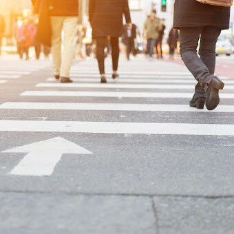 Pedestrians in Crosswalk A lot of people are walking on the crosswalk in big city streets in working day.