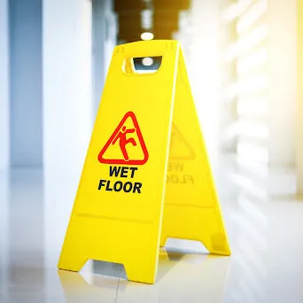 Sign showing warning of wet floor on wet floor