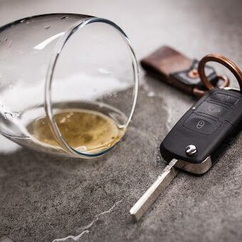 Drunk driving concept - spilled beer and car keys on a table